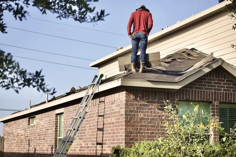 Professional roofer working on a residential roof in Trinity Mills